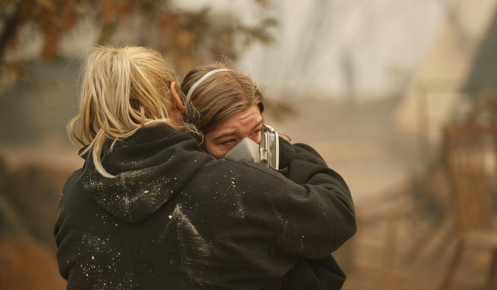 Krystin Harvey, left, comforts her daughter Araya Cipollini at the remains of their home in Paradise, California. Photo: AP