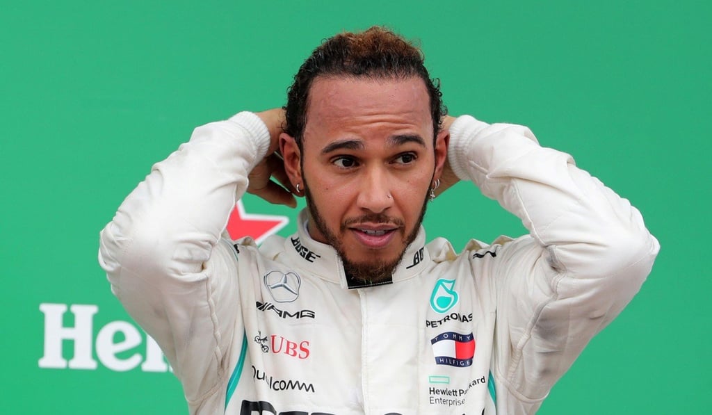 Lewis Hamilton celebrates on the podium after winning the Brazilian Grand Prix. Photo: Reuters