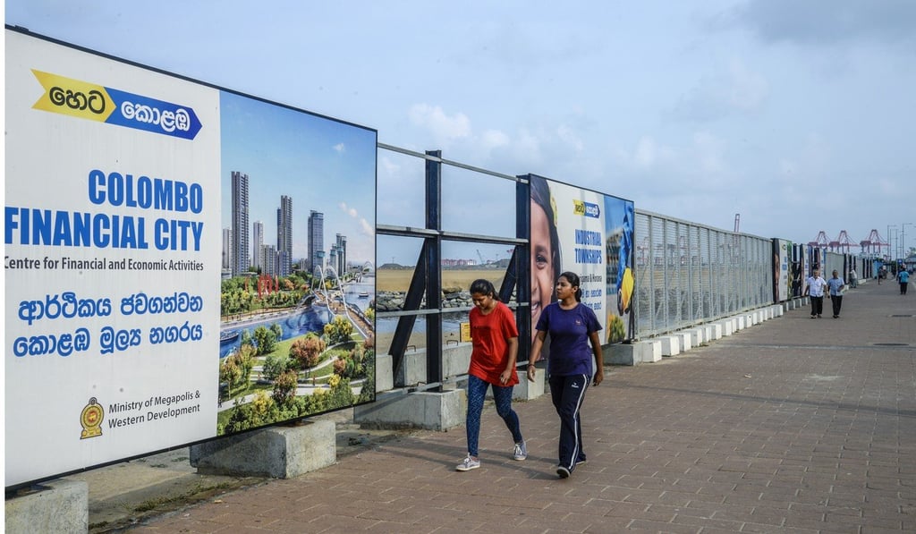 People walk past an advert for the Colombo International Financial City project in Sri Lanka, another of China’s massive investment projects in the South Asian nation. Photo: Bloomberg