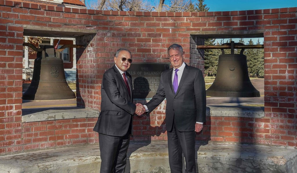 Romualdez and Mattis pose in front of the bells. Photo: AFP