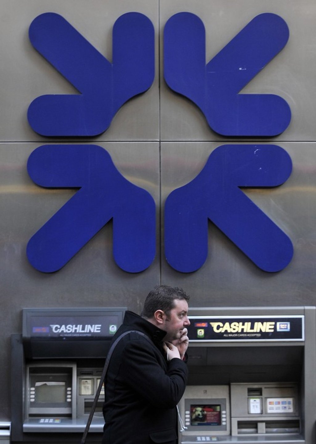 File photo of a pedestrian walking past a Royal Bank of Scotland branch in London. Photo: EPA