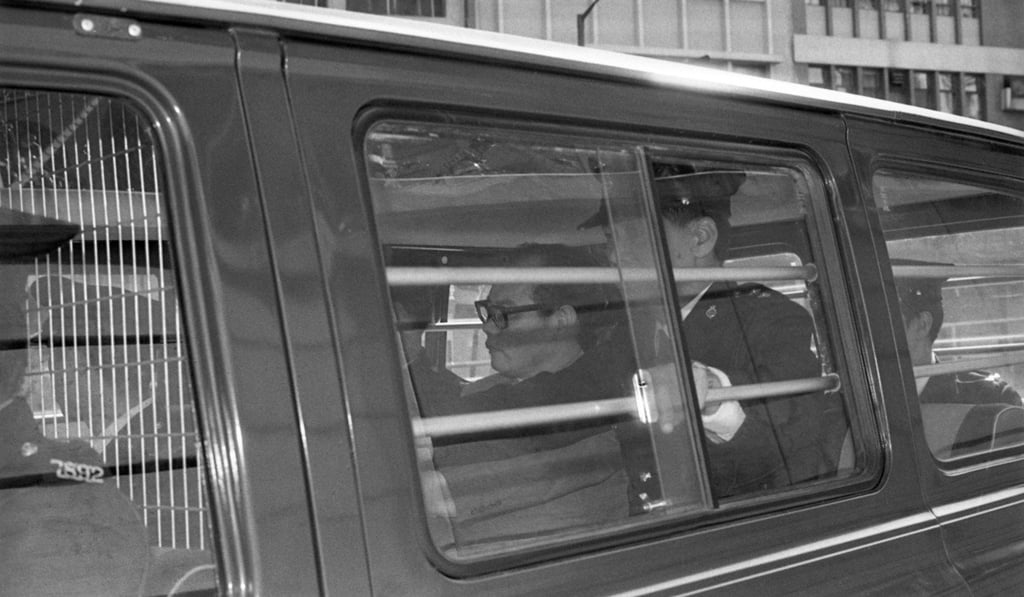 Ho is driven to court to give evidence at a committal hearing, in 1977.