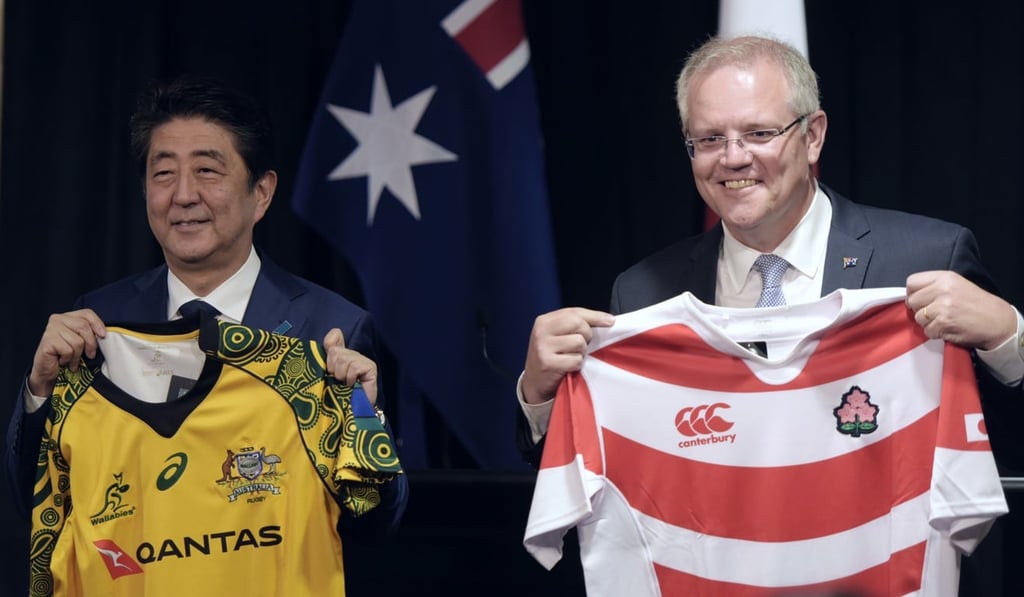 Abe and Morrison exchanged national rugby jerseys after their talks. Photo: AP Abe and Morrison exchanged national rugby jerseys after their talks. Photo: AP