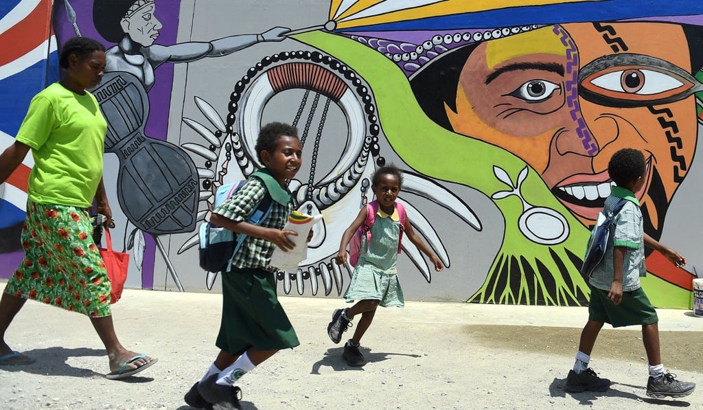 Children head home after school in Port Moresby, the Papuan capital. Photo: AFP