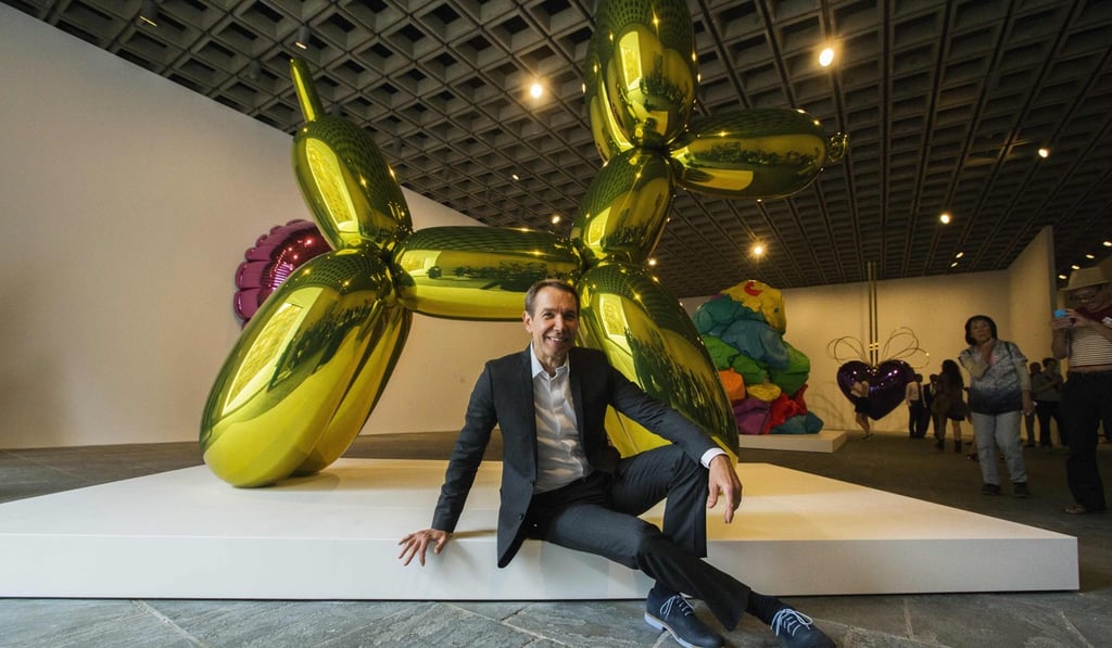Artist Jeff Koons poses with one of his ‘balloon dog’ sculptures at the Whitney Museum of American Art in New York in June, 2014. Photo: Reuters