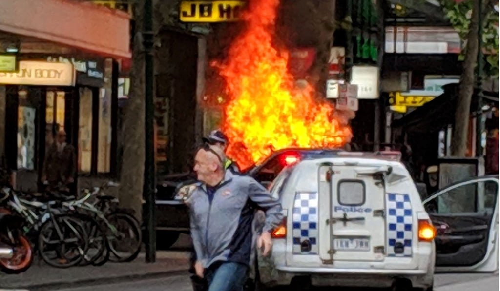 A car set on fire during Hassain Khalif Shire Ali’s rampage in Melbourne’s central business district on November 9, 2018. Photo: Chris Newport/Instagram/AFP