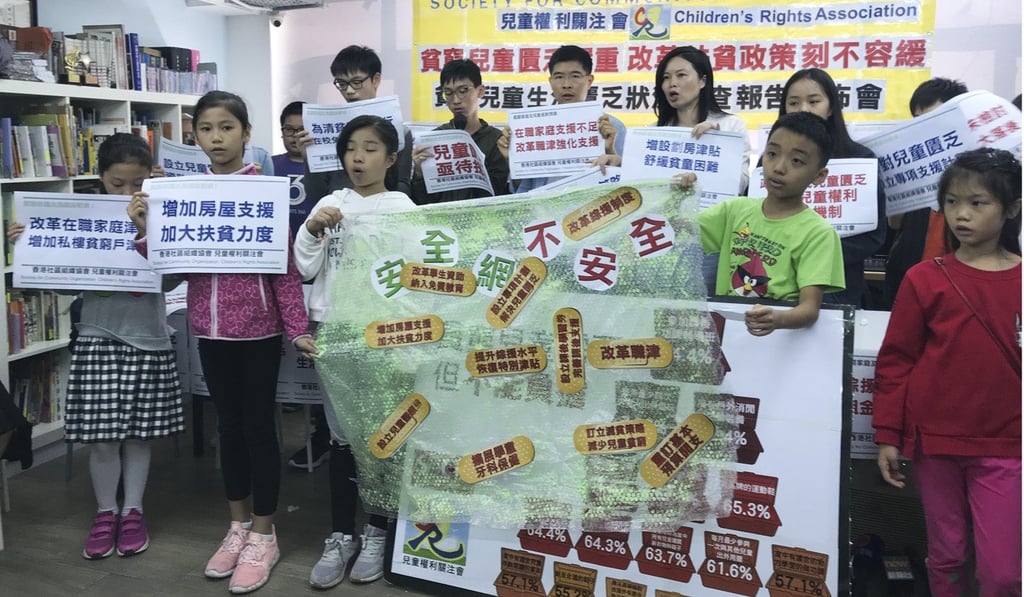 Community organisers Sze Lai-shan and Wong Chi-yuen are flanked by children living in poverty at an event to present the study on Sunday. Photo: Mary Ann Benitez