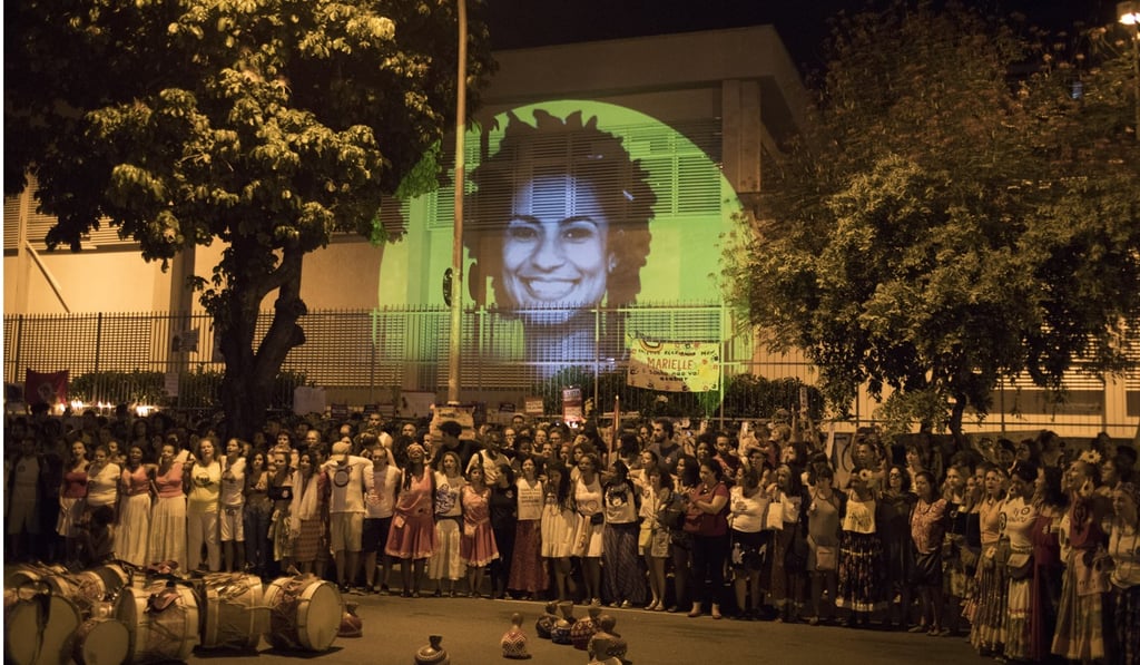 An April 2018 photo shows an image of slain councilwoman Marielle Franco projected on a wall during a protest at the site where Franco and her driver were killed. Photo: AP