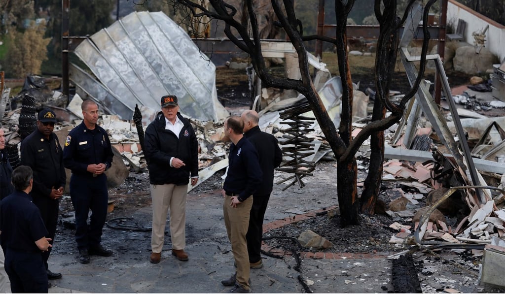 US President Donald Trump looking at homes destroyed by fire in Malibu, California on November 17, 2018. Photo: Reuters