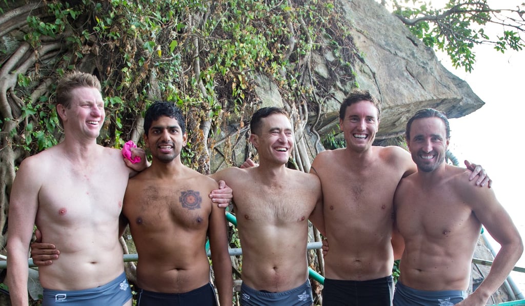 (From left) Nick Miller, Ram Krishnan, Andrew Young, Ben Butlin and Tom Butlin after finishing their around the Island swim. Photo: Maxime Vanhol