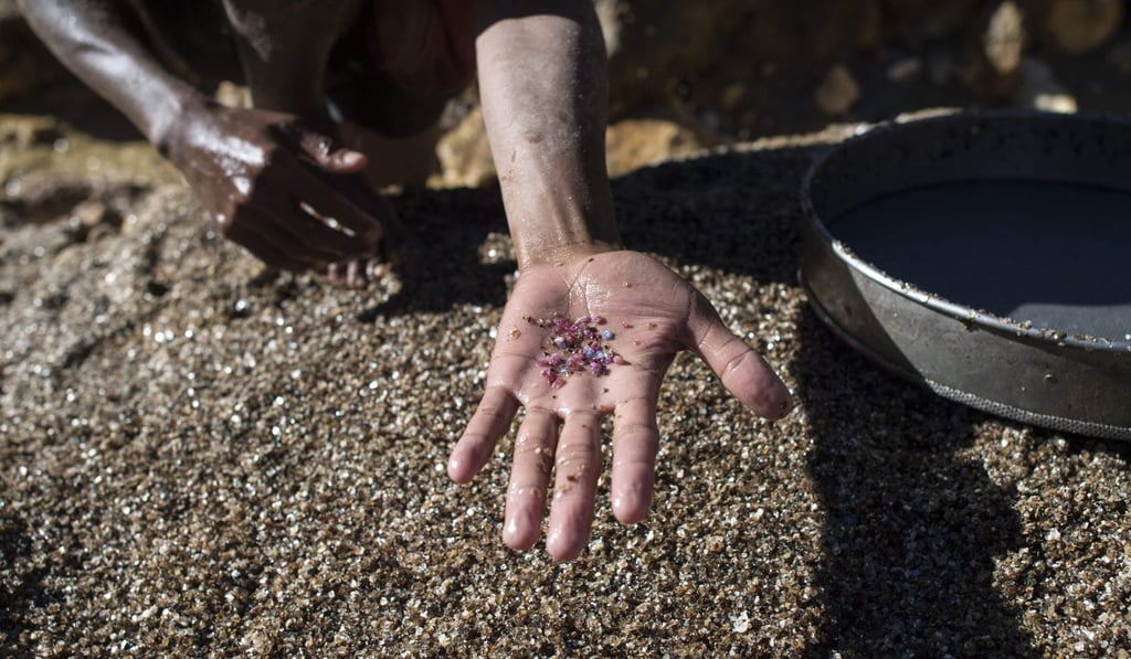 A man holds out pieces of ruby and jade found at a mine in Mogok, north of Mandalay. Photo: AFP