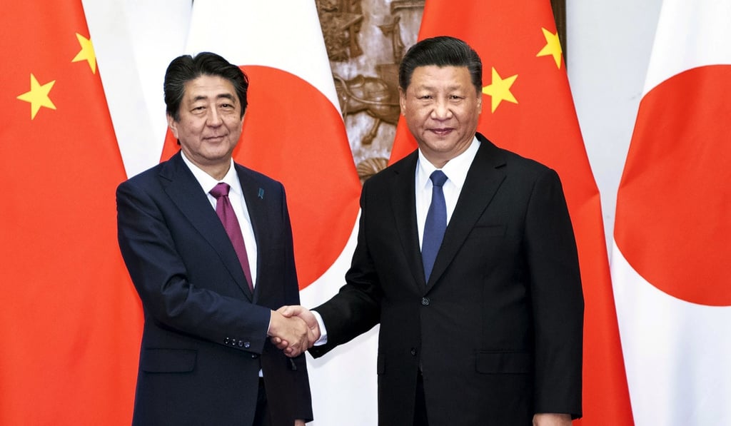 Japanese Prime Minister Shinzo Abe (left) shakes hands with Chinese President Xi Jinping before a meeting at the Diaoyutai State Guesthouse in Beijing, on October 26. Abe was the first Japanese prime minister to visit China since 2011. Photo: Xinhua