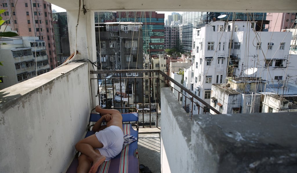 A man sleeps on the roof of an old building in Sham Shui Po. Photo: Sam Tsang
