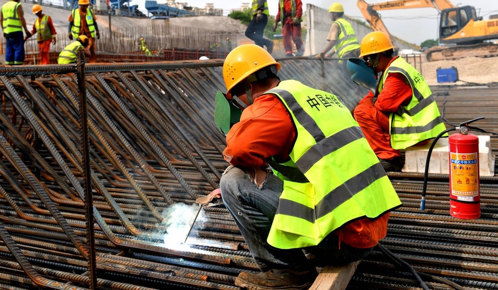 Builders weld steel bars at a construction site in the pilot free-trade zone of Qianhai and Shekou, in Shenzhen. Infrastructure spending was a bright spot for China’s economy in October. Photo: Xinhua