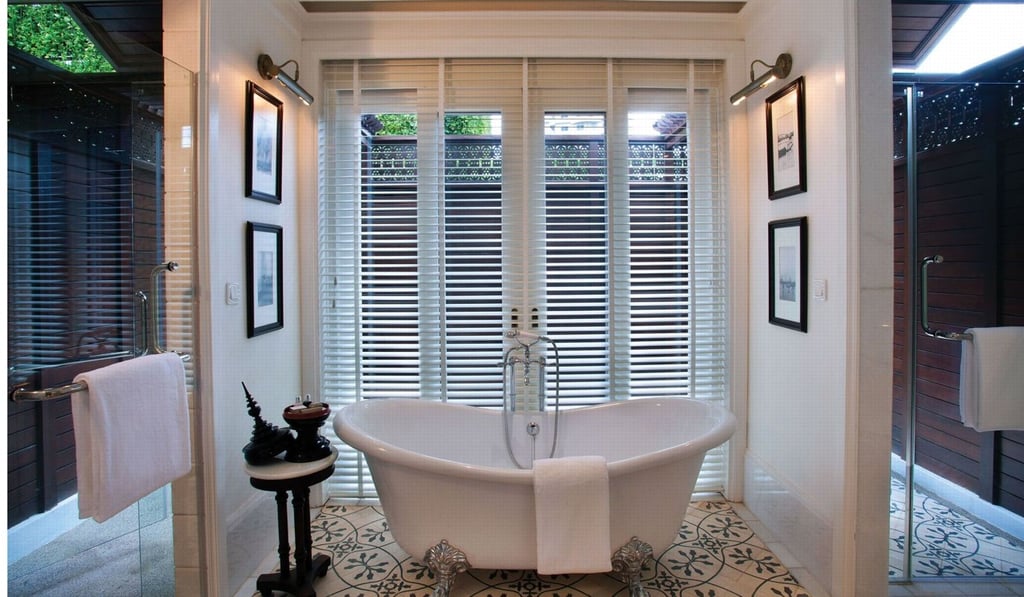 Elegant shutters provide privacy while letting in the light in a bathroom at the boutique hotel, 137 Pillars House, in Chiang Mai, Thailand. Elegant shutters provide privacy while letting in the light in a bathroom at the boutique hotel, 137 Pillars House, in Chiang Mai, Thailand.