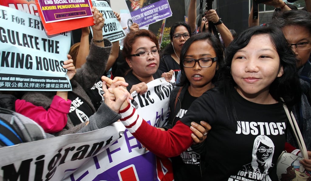 Indonesian domestic worker Erwiana Sulistyaningsih (right) with her supporters outside Wan Chai District Court following the sentencing of her former employer Law Wan-tung.
