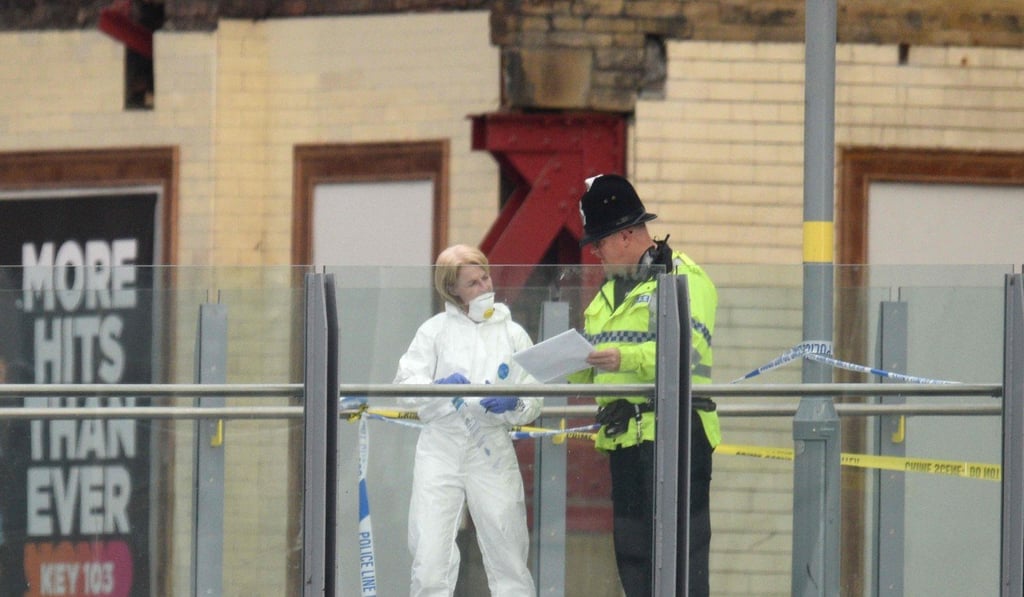In this file photo taken on May 23, 2017 a forensic officer collects evidence on a walkway between Victoria station and Manchester Arena following a deadly terror attack in Manchester. Photo: AFP