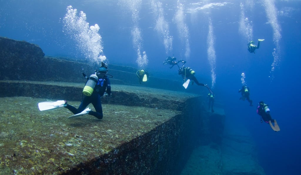 Scuba divers explore the upper terrace of the Yonaguni monument. Photo: Alamy