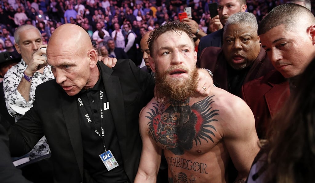 Conor McGregor is escorted from the cage area after fighting Khabib Nurmagomedov at UFC 229. Photo: AP Conor McGregor is escorted from the cage area after fighting Khabib Nurmagomedov at UFC 229. Photo: AP