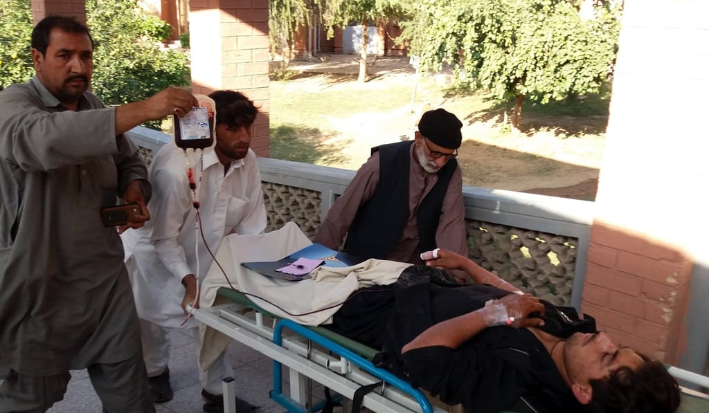 An injured man is taken for treatment following the blast. Photo: EPA