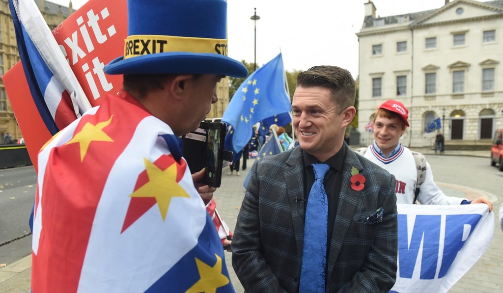 Tommy Robinson speaks to an anti Brexit protester outside the Houses of Parliament in London on November 6, 2018. Photo: EPA