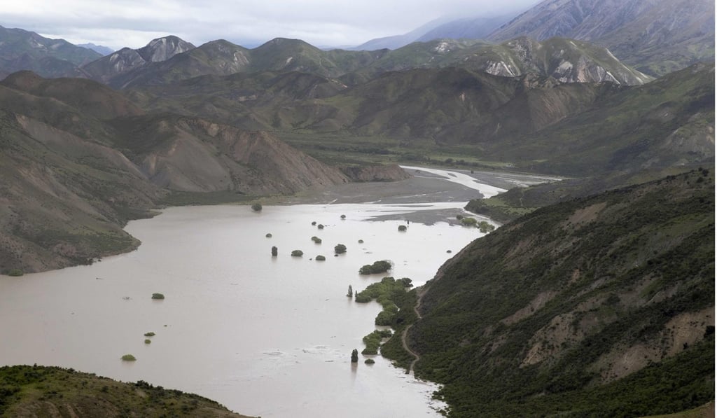 Dust created by a strong after-shock hanging above the Clarence River which was blocked, causing a huge dam, north of Kaikoura on the South Island’s east coast in November 2016. Photo: AFP