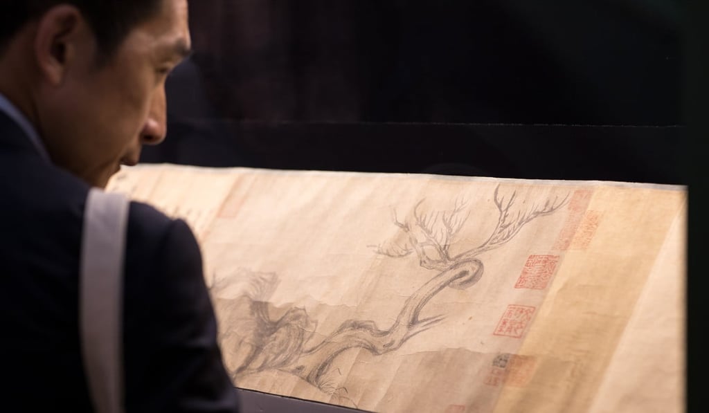 A visitor looks at Wood and Rock by Chinese artist Su Shi during an auction preview in Hong Kong, China. The painting sold for HK$463.6 million. Photo: EPA-EFE