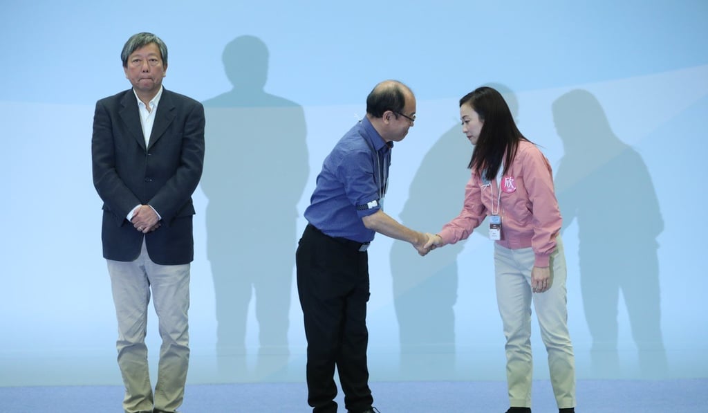 Frederick Fung shakes hands with Chan Hoi-yan after Chan wins the Legco Kowloon West by-election, with Lee Cheuk-yan on the left. Photo: Sam Tsang