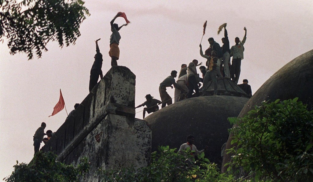 A December 6, 1992 photo of Hindu fundamentalists shouting and waving banners as they celebrate the destruction of the Babri Mosque in Ayodhya. Photo: AFP