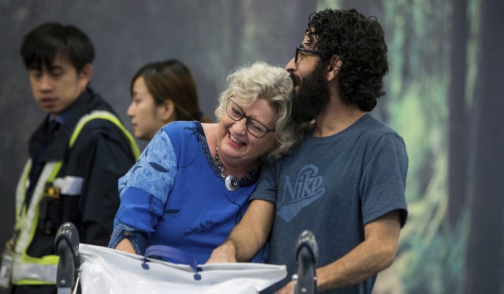 Supporter Laurie Cooper embraces al-Kontar after his arrival in Vancouver. Photo: AP