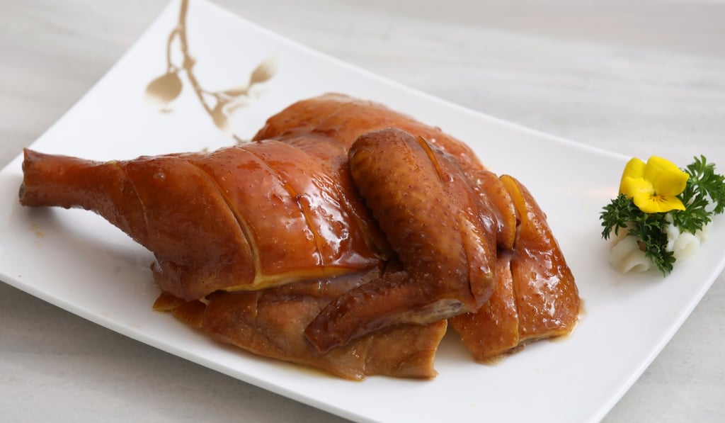Soy sauce chicken with sand ginger, onion and garlic in casserole (half). Photo: K.Y. Cheng