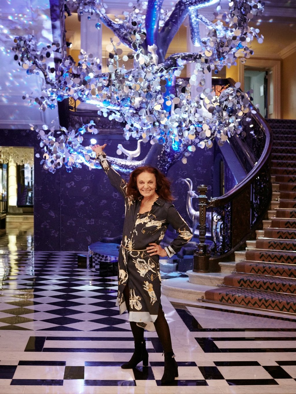 Fashion designer Diane von Furstenberg stands beside her Christmas tree in the lobby.