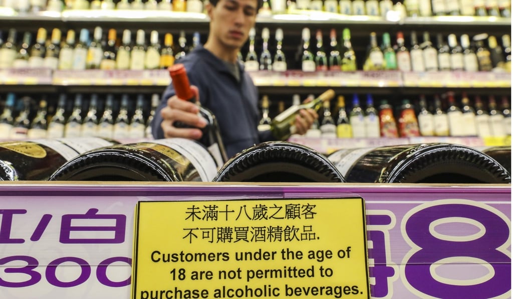 Warning signs next to wine bottles for sale at a Wellcome supermarket in Causeway Bay. Photo: Dickson Lee