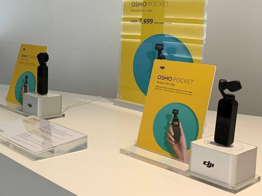 A display of the DJI Osmo Pocket, which features a small one-inch touch screen and a three-axis mechanical gimbal, which helps to compensate for camera movement.