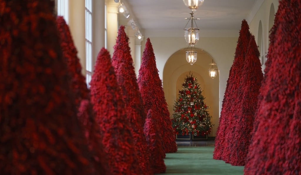 Red trees line the east colonnade of the White House. Photo: AP