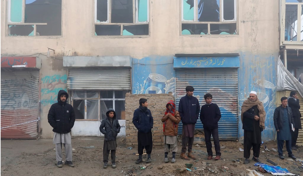 Afghan residents stand at the site of a car-bomb attack in Kabul, Afghanistan, November 29, 2018. Photo: Reuters