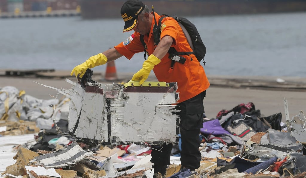 A file photo of a rescuer inspecting parts of Lion Air Flight 610 retrieved from the waters off Java Island. Photo: AP A file photo of a rescuer inspecting parts of Lion Air Flight 610 retrieved from the waters off Java Island. Photo: AP
