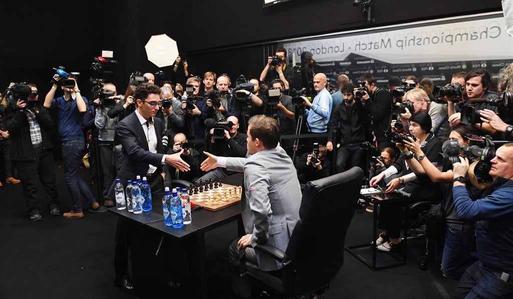 Norway's World Chess Champion Magnus Carlsen (centre) plays against US challenger Fabiano Caruana (left) in a tiebreak game during the World Chess Championship in London. Photo: EPA