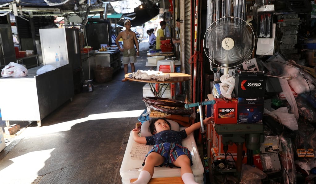 A child relaxes under the electronic fan on a hot day in Sham Shui Po during the heatwave that hit the city in May. Photo: Sam Tsang