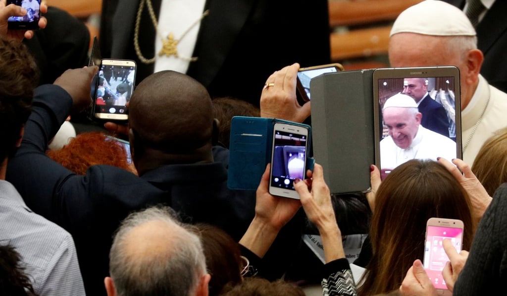 People take photos as Pope Francis at the Vatican on November 30, 2018. Photo: Reuters