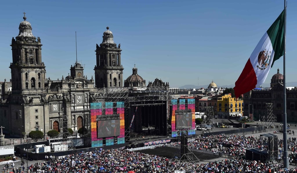 People at the Zocalo square, in Mexico City, watch on a huge screen the inauguration ceremony of Mexico president-elect Andres Manuel Lopez Obrador being held at the Congress of the Union, on December 1, 2018. Photo: AFP