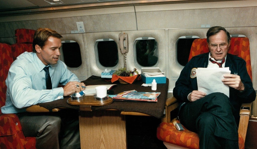 Arnold and George H.W. Bush get to work aboard Air Force One. Photo: Twitter