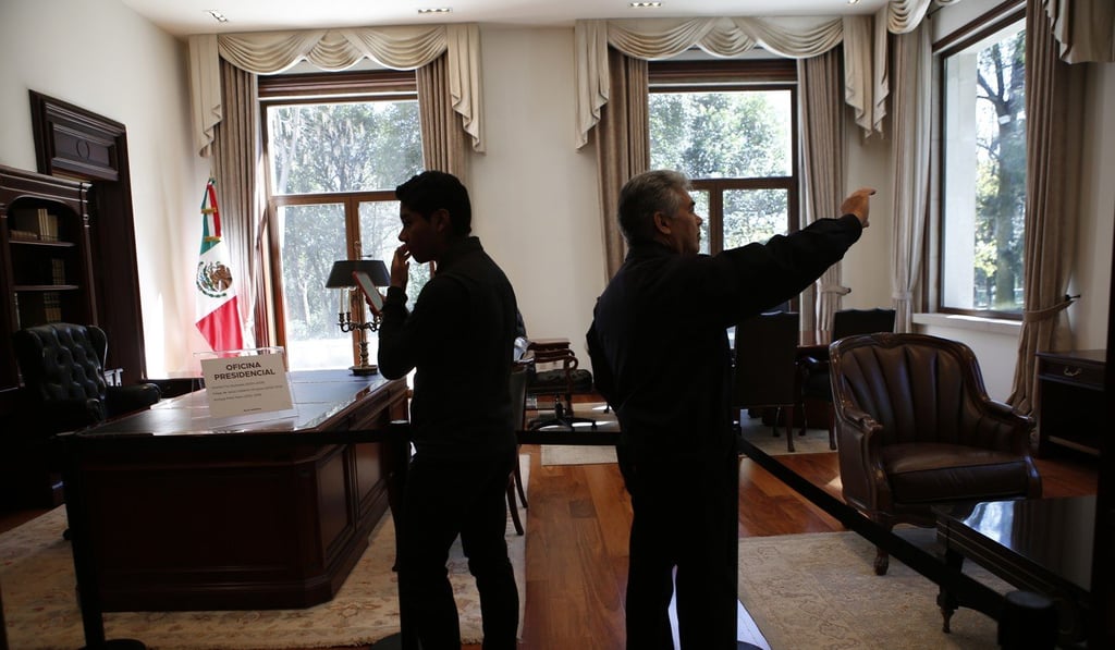 Visitors take photos inside the presidential office. Photo: AP