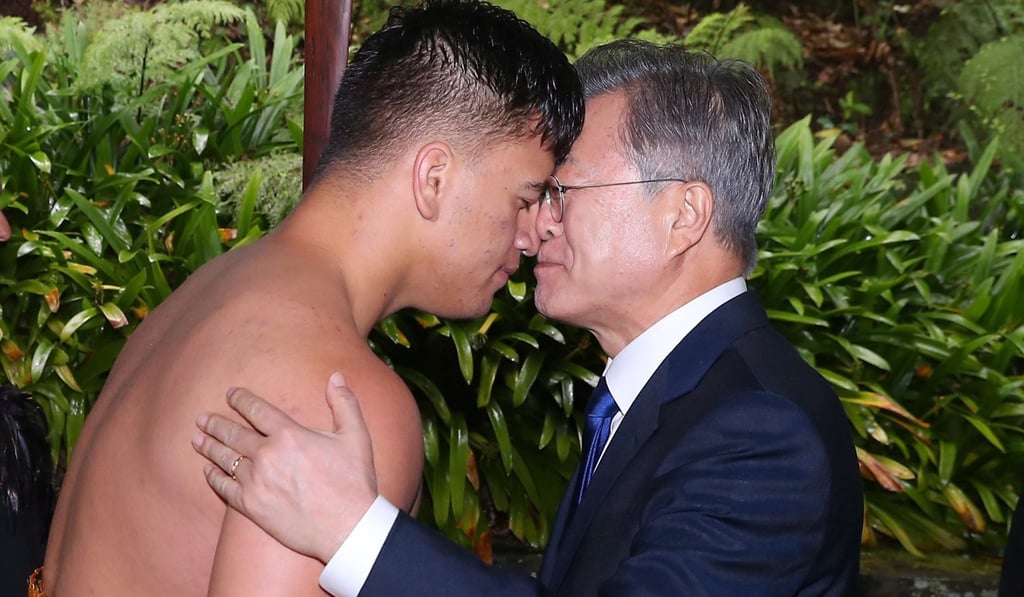 South Korean President Moon Jae-in, right, rubs noses with a Maori dance performer during a welcome ceremony in Auckland, New Zealand, where he is making an official visit. Photo: EPA South Korean President Moon Jae-in, right, rubs noses with a Maori dance performer during a welcome ceremony in Auckland, New Zealand, where he is making an official visit. Photo: EPA