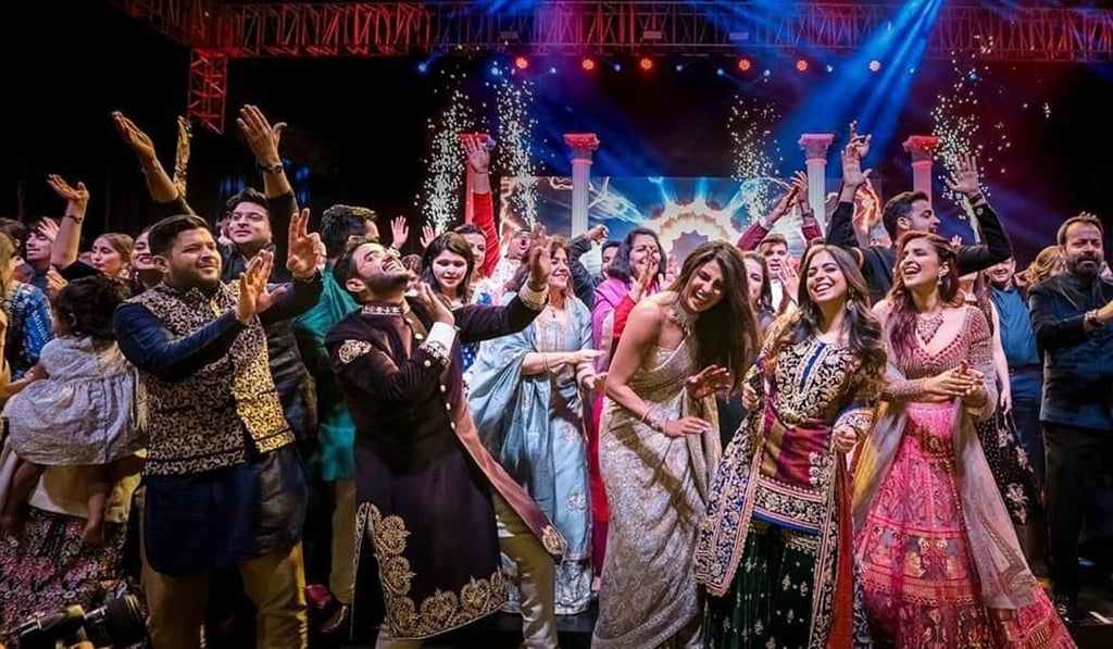 Bollywood actress Priyanka Chopra (centre right) dances with guests during a ceremony before her wedding with Nick Jonas.
