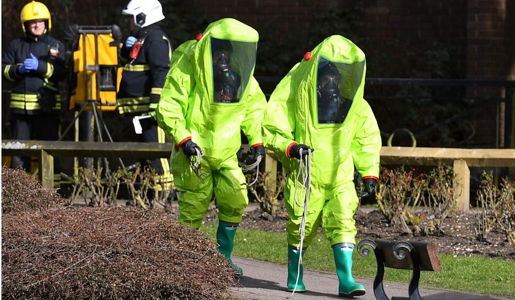 Members of the fire brigade in green biohazard suits investigating the poisoning incident in Salisbury in March, 2018. Photo: AFP