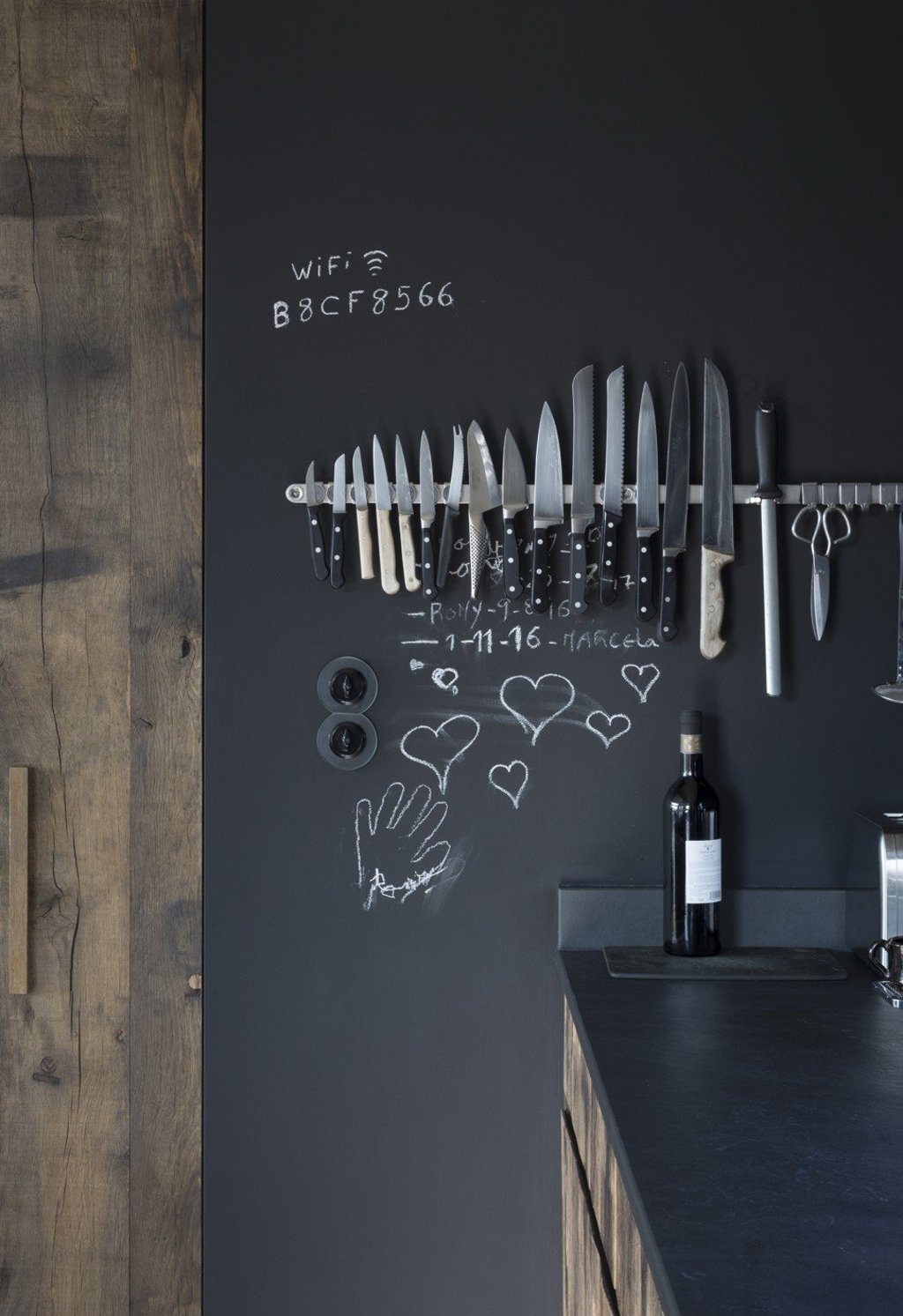 Knives are displayed on the kitchen wall, giving it a quirky touch.