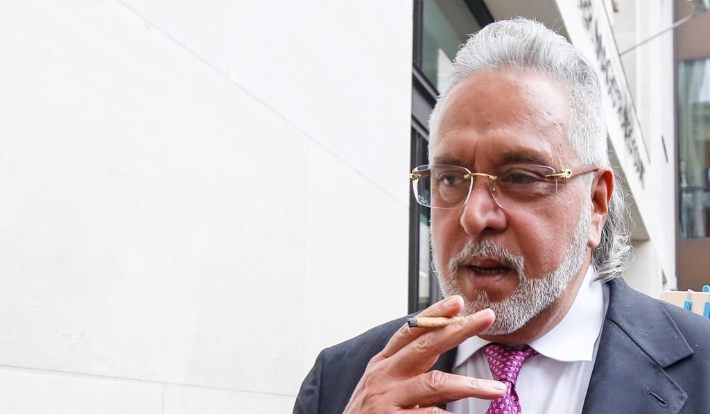 Mallya smokes as he leaves an extradition hearing in London on September 12. Photo: Bloomberg