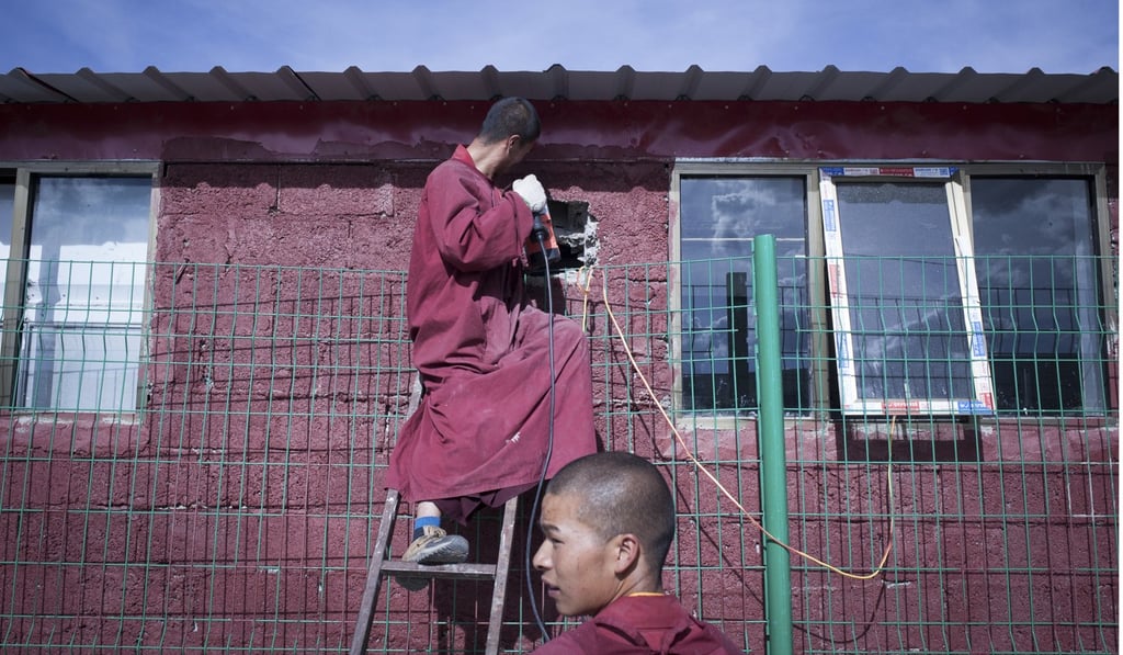 Monks carry out maintenance work.