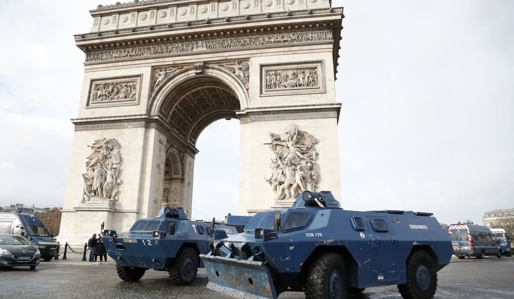 Armoured personnel carriers parked in front of the Arc de Triomphe. Photo: AP